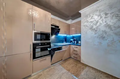 a large kitchen with white cabinets and appliances at Luxe Apartment Olymp in Sveti Vlas in Sveti Vlas