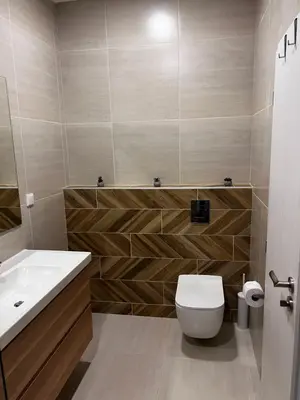 a bathroom with a white toilet and a sink at Las Brisas Garden Apartment in Burgas City