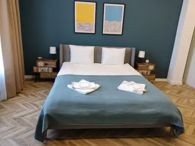 a bedroom with a bed with two towels on it at Las Brisas Garden Apartment in Burgas City