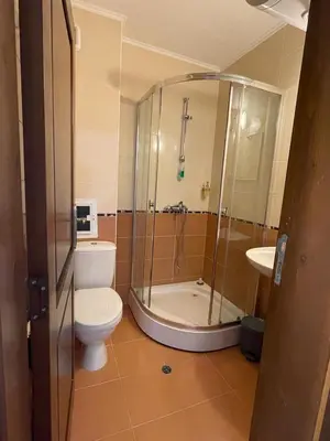 a bathroom with a shower and a toilet and a sink at HELIOS I premium in Sveti Vlas