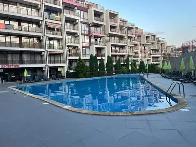 a large swimming pool in front of a building at HELIOS I premium in Sveti Vlas