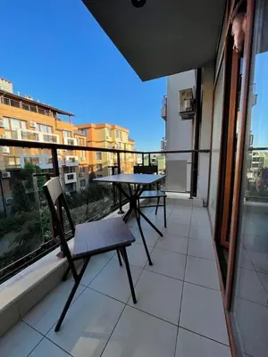 a balcony with a table and chairs on a building at HELIOS I premium in Sveti Vlas