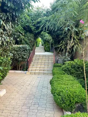 a stairway with a set of stairs in a garden at HELIOS I premium in Sveti Vlas