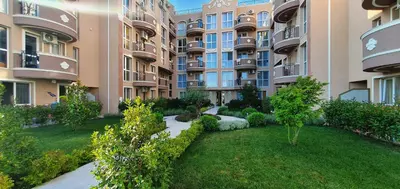 an apartment building with a garden in front of it at Apartments Vilma&Villiam in Ravda