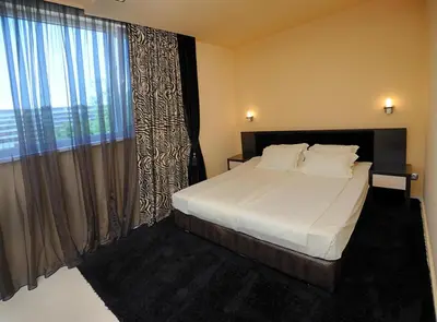 a bedroom with a bed and a large window at Heaven Lux Apartments in Sunny Beach
