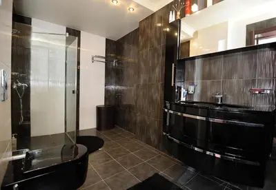 a bathroom with a glass shower and a toilet at Heaven Lux Apartments in Sunny Beach