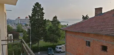 a view of a building from a balcony of a house at Ivet Guest Rooms - Obzor in Obzor