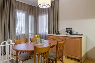 a kitchen and dining room with a table and chairs at Black Sea Dolphin Apartment in Varna City