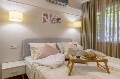 a living room with a bed and a table at Black Sea Dolphin Apartment in Varna City
