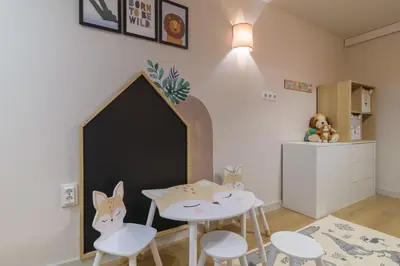 a childs room with a table and chairs and a dog door at Black Sea Dolphin Apartment in Varna City