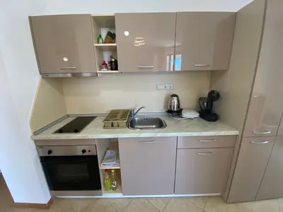 a small kitchen with white cabinets and a sink at ROYAL SUN O 31 Apartment Royal Sun in Sunny Beach