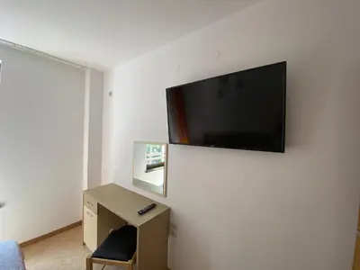 a room with a desk and a flat screen tv on a wall at ROYAL SUN O 31 Apartment Royal Sun in Sunny Beach