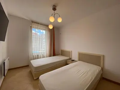 a hotel room with two beds and a window at ROYAL SUN O 31 Apartment Royal Sun in Sunny Beach