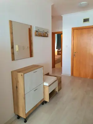 a bathroom with a dresser and a mirror on the wall at Sveti Vlas Marina Beach Apartment - Vega Village in Sveti Vlas