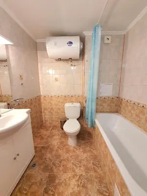 a bathroom with a toilet and a bath tub at Sveti Vlas Marina Beach Apartment - Vega Village in Sveti Vlas