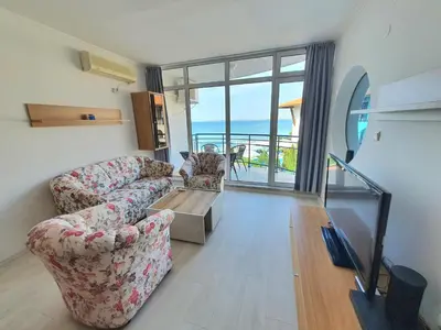 a living room with two couches and a view of the ocean at Sveti Vlas Marina Beach Apartment - Vega Village in Sveti Vlas