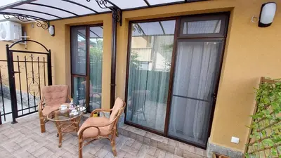 a patio with a table and chairs on a balcony at Sunrise City A1, Sarafovo in Burgas City