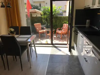 a kitchen and dining room with a table and chairs at Sunrise City A2, Sarafovo in Burgas City