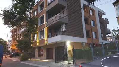 a building on a street with a car parked in front at Sunrise City A2, Sarafovo in Burgas City