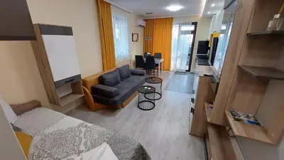 a living room with a bed and a couch at Sunrise City A2, Sarafovo in Burgas City