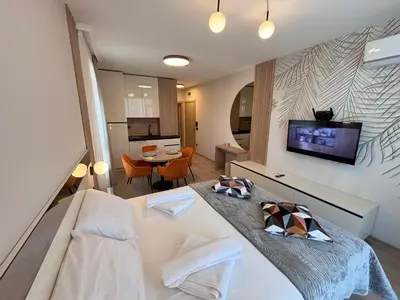 a room with a bed and a tv on a wall at Sorrento - Menada Apartments in Sveti Vlas