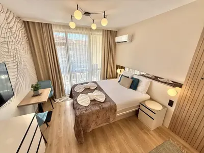 a hotel room with a bed and a desk at Sorrento - Menada Apartments in Sveti Vlas
