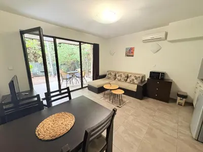a living room with a table and a couch at The White Houses Complex in Nesebar