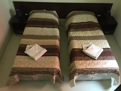 two beds sitting next to each other in a room at The White Houses Complex in Nesebar