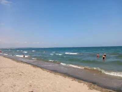a group of people in the water at the beach at Апартамент Морски оазис in Burgas City