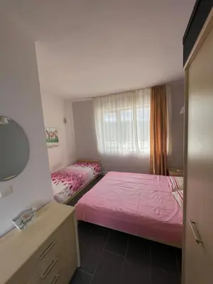 a bedroom with a pink bed and a window at YooBulgaria-Obzor SP apartments in Obzor