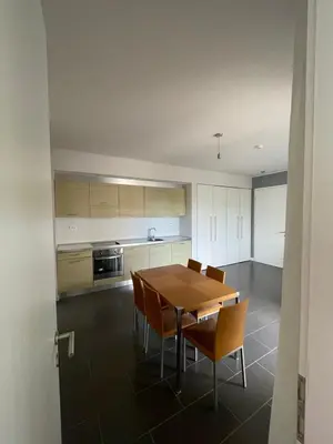 a kitchen with a wooden table and chairs at YooBulgaria-Obzor SP apartments in Obzor