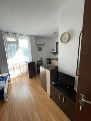 a living room with a clock on the wall at Villa Flora SP apartments in Ravda