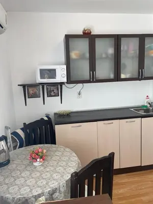 a kitchen with a table and a counter top at Villa Flora SP apartments in Ravda