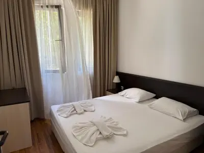 a bedroom with two white towels on a bed at Marina Cape SP private apartments in Aheloy