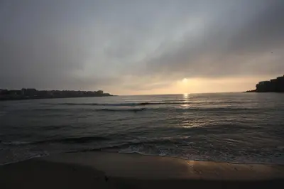a sunset on the beach with the ocean at Effect Saint Mina in Sozopol