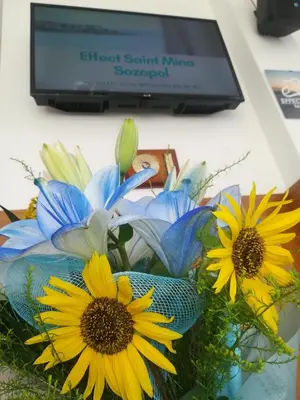 a bouquet of flowers in front of a computer monitor at Effect Saint Mina in Sozopol