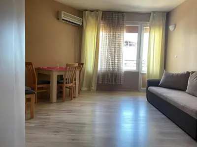 a living room with a couch and a table at Cozy 1BD Apartment with a Lovely Sea View by Flat Mаnаger in Sveti Vlas