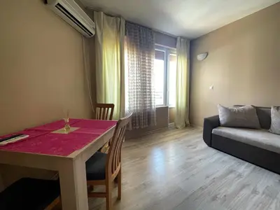 a living room with a table and a couch at Cozy 1BD Apartment with a Lovely Sea View by Flat Mаnаger in Sveti Vlas