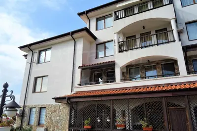 a tall white building with windows and a balcony at Sveti Vlas Kambani Bells 3 Ap 7a in Sveti Vlas