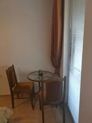 a small table and chairs in a room at Sveti Vlas Kambani Bells 3 Ap 7a in Sveti Vlas