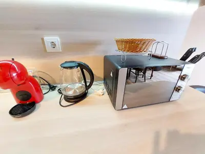 a toaster oven sitting on top of a counter at Апартаменти за гости Делукс in Burgas City