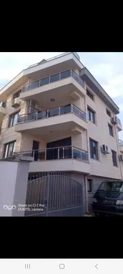 a tall building with a car parked in front of it at Венета 1 in Sozopol