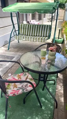 a glass table and a chair and a bench at Венета 1 in Sozopol