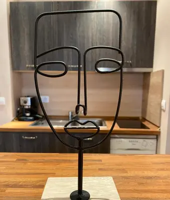 a black metal object sitting on a table in a kitchen at AJ Apartment 1 with Pool view, Santa Marina Holiday Village, Sozopol in Sozopol