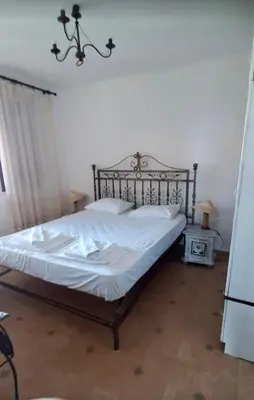 a bedroom with a large bed with white sheets at Complex Monastery 1 -Marina Dinevi -Saint Vlas in Sveti Vlas