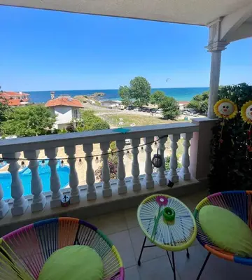 a balcony with chairs and a view of the ocean at Perla Del Mar Studio PANORAMA First line in Lozenets
