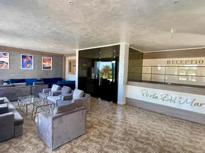 a lobby of a hotel with couches and a bar at Perla Del Mar Studio PANORAMA First line in Lozenets