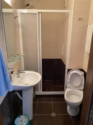 a bathroom with a toilet and a sink and a shower at The modern apartment in the ancient city in Sozopol