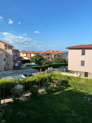 a view of the garden from the balcony of a building at The modern apartment in the ancient city in Sozopol