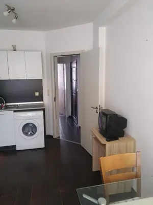 a kitchen with a washing machine and a microwave at Хаджи Иванов in Varna City
